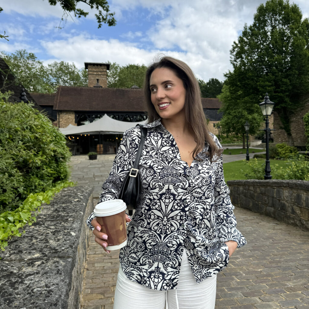 Lady wearing transitional clothing pieces outdoors 