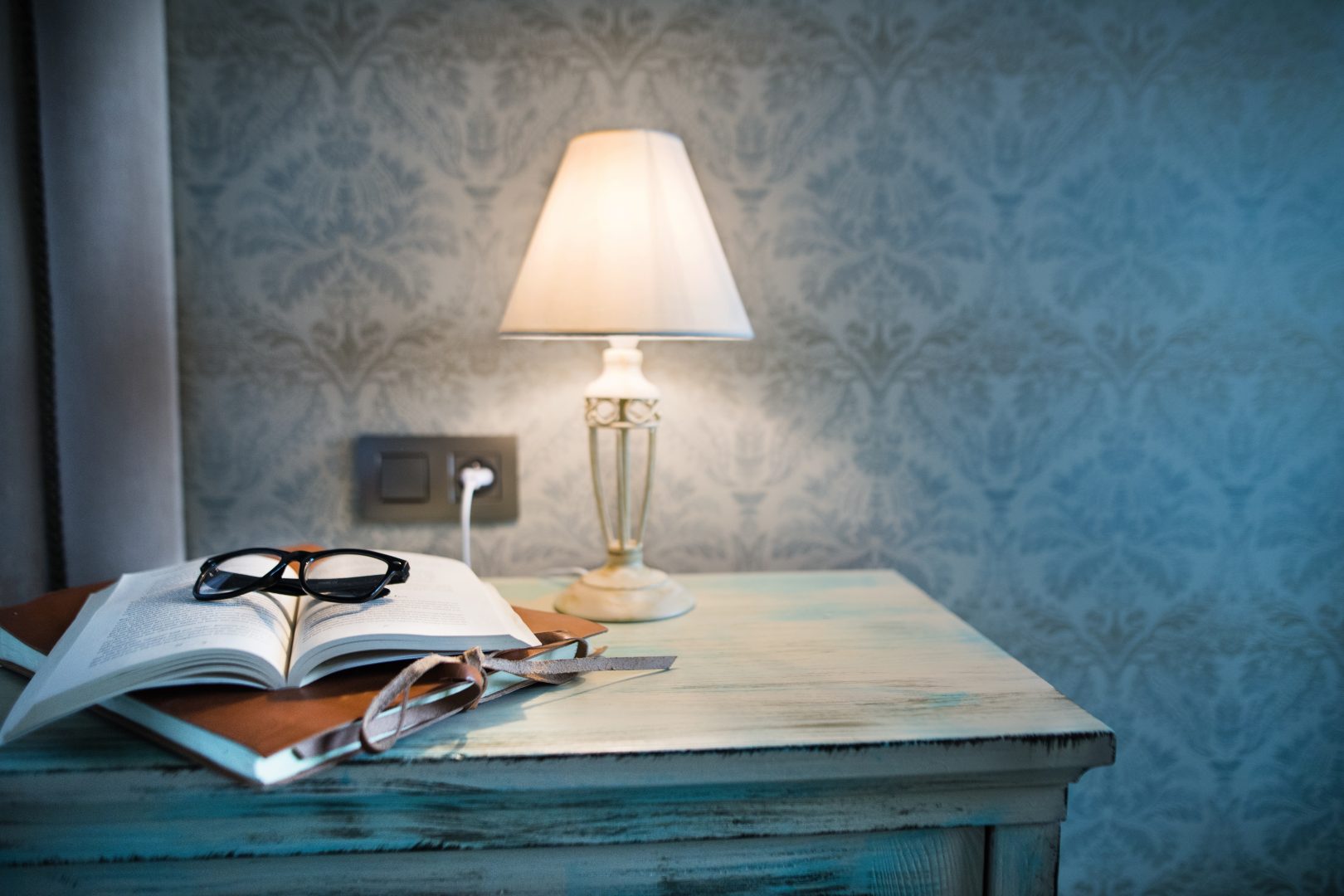 book and lamp on bedside table