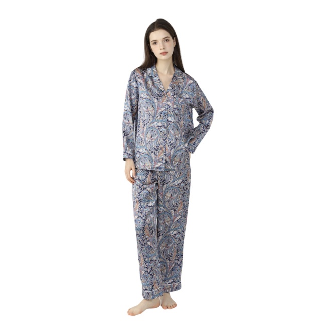Brunette Lady wearing silk pyjamas in a dark blue paisley print
